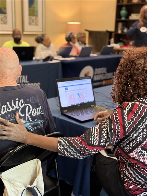 Photo of two residents working on a digital skilling module together.